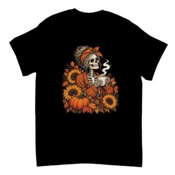 Skeleton Coffee Shirt in black with a skeleton in an orange cardigan and headband holding a steaming mug among sunflowers, a pumpkin and autumn leaves
