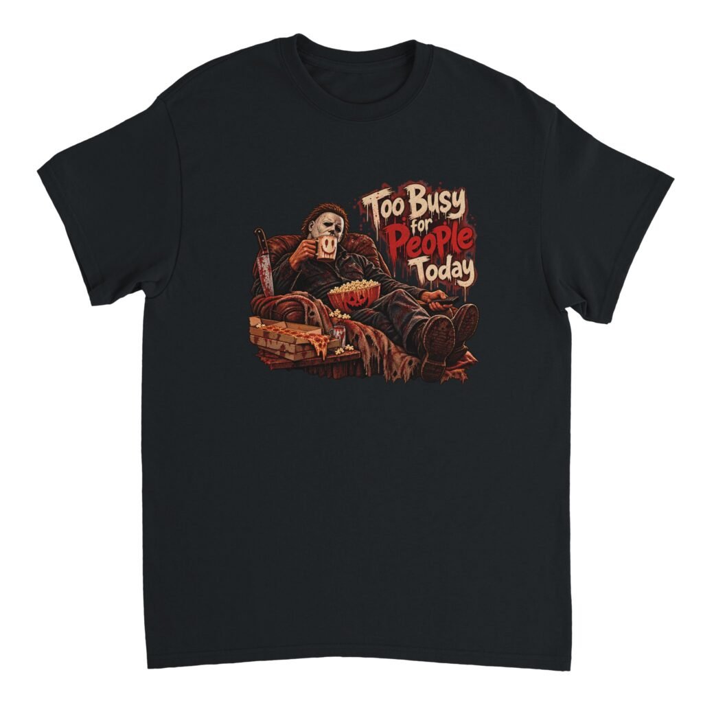 Halloween slasher shirt design of a masked figure in a white mask relaxing in an armchair with popcorn, pizza and a smiley mug beside the text Too Busy for People Today